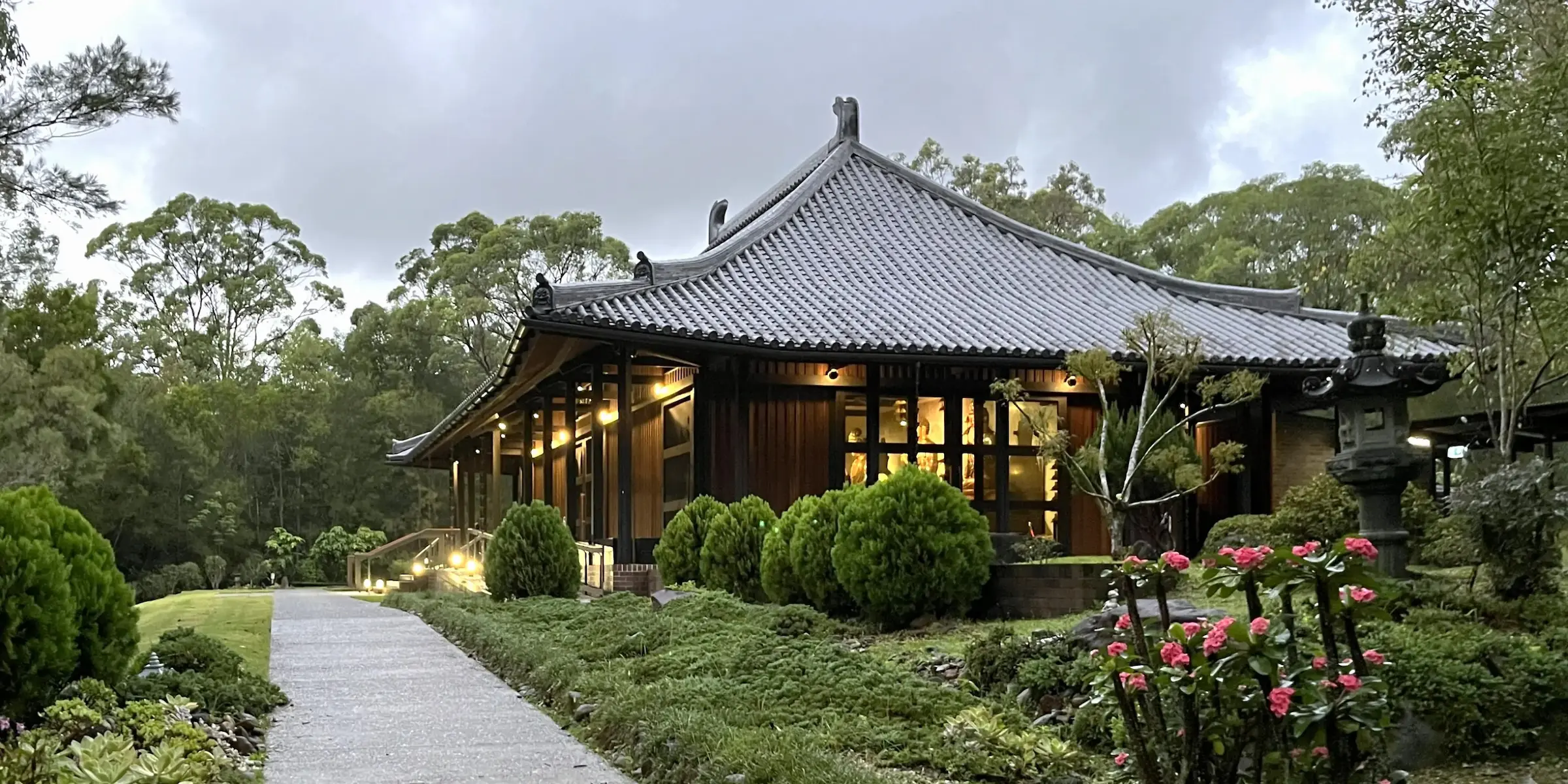 The exterior of the Main Buddha Hall with traditional curved roofline and manicured gardens